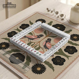 Beige mahjong mat with a botanical floral bird design, blush flowers, olive green leaves, black flower accents, and a warm linen-style background. Scalloped edge option shown.