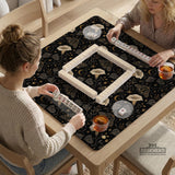 Black square mahjong mat with moths, moonflowers, crescent moons, and scattered stars in a celestial floral pattern.