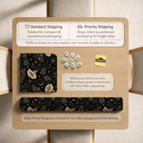 Black square mahjong mat with moths, moonflowers, crescent moons, and scattered stars in a celestial floral pattern.