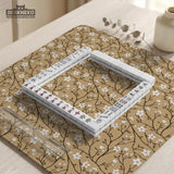 Beige mahjong mat with a white blossom branch floral pattern on a neutral background.