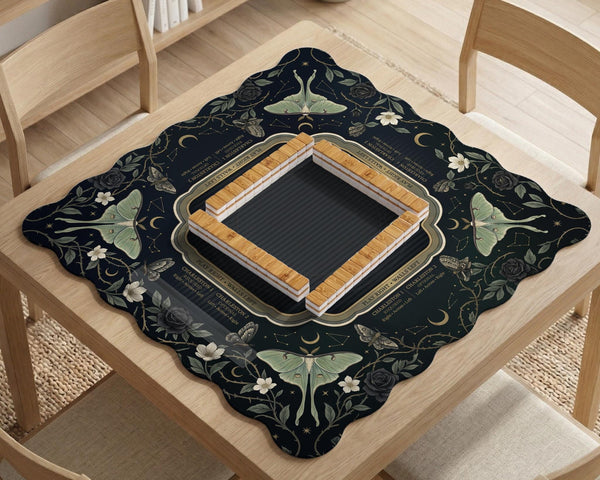 A dark floral mahjong mat with a scalloped edge, moth and flower artwork, and an American Mahjong rules layout on a dark background.
