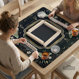 A dark floral mahjong mat with a scalloped edge, moth and flower artwork, and an American Mahjong rules layout on a dark background.