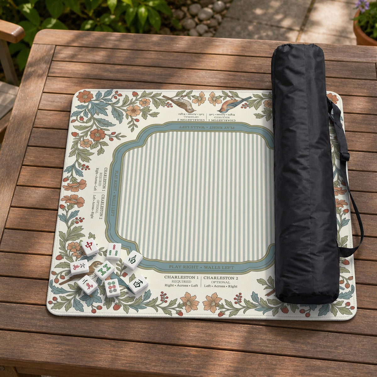 Square mahjong mat with a cream background, blue birds, sage leaves, terracotta flowers, and a decorative botanical border with printed rules text.