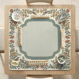 Square mahjong mat with a cream background, blue birds, sage leaves, terracotta flowers, and a decorative botanical border with printed rules text.