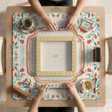 Cream mahjong mat with a coral and teal floral border, rule layout text, Charleston guide notes, and a blank center area for tile play.