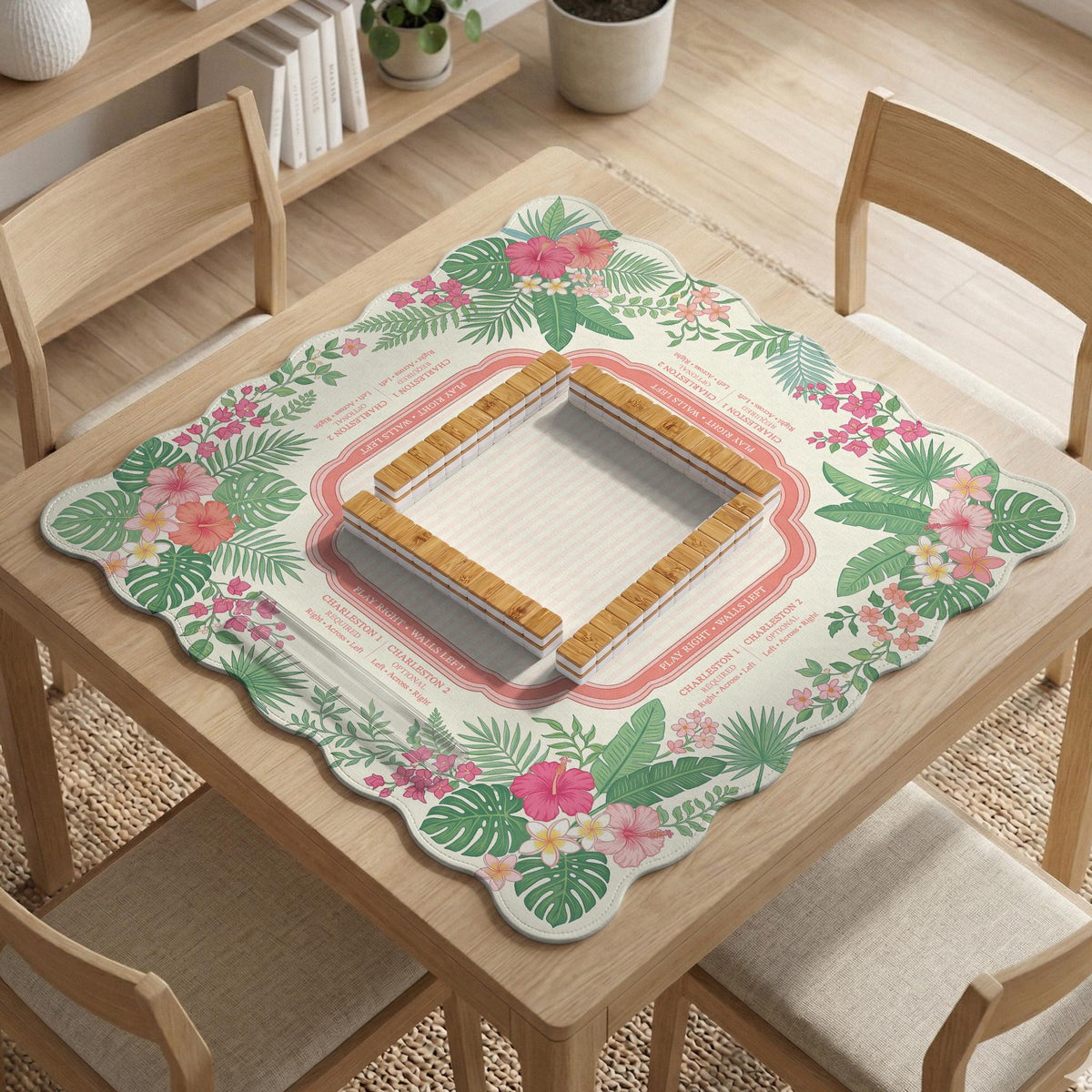 Coral tropical floral mahjong mat with hibiscus flowers, palm leaves, cream sections, and a scalloped edge.