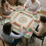 Coral tropical floral mahjong mat with hibiscus flowers, palm leaves, cream sections, and a scalloped edge.