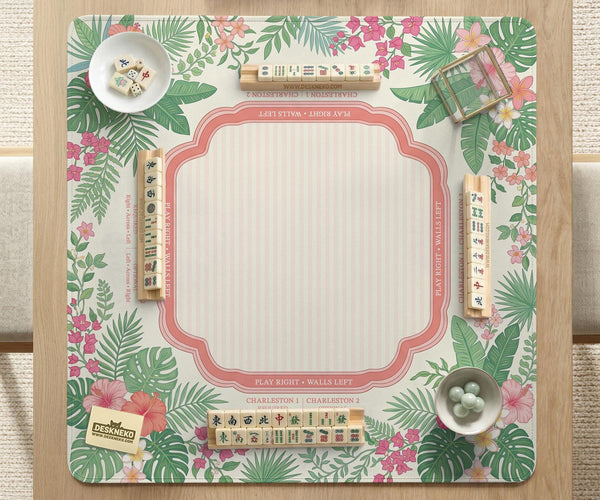 Coral tropical floral mahjong mat with hibiscus flowers, palm leaves, cream sections, and a scalloped edge.