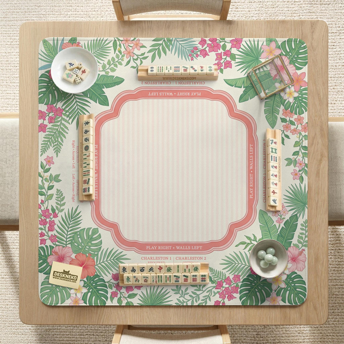 Coral tropical floral mahjong mat with hibiscus flowers, palm leaves, cream sections, and a scalloped edge.