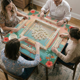 Pink mahjong mat with flamingos, palm leaves, hibiscus flowers, and aqua tropical background.