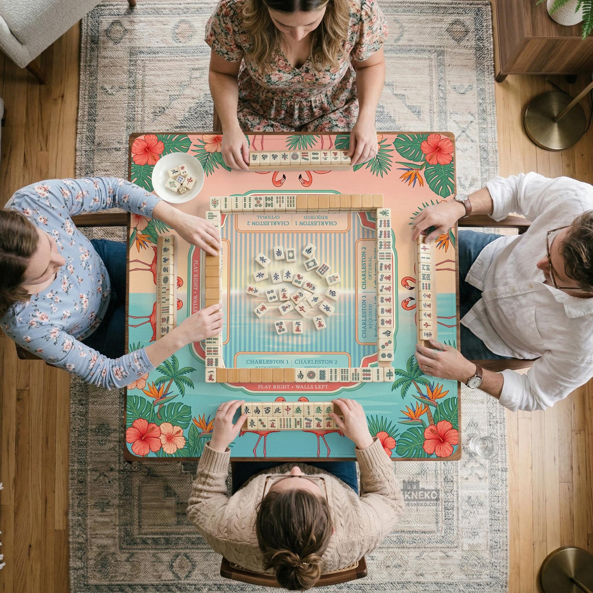 Pink mahjong mat with flamingos, palm leaves, hibiscus flowers, and aqua tropical background.