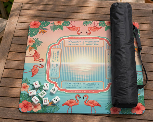 Pink mahjong mat with flamingos, palm leaves, hibiscus flowers, and aqua tropical background.