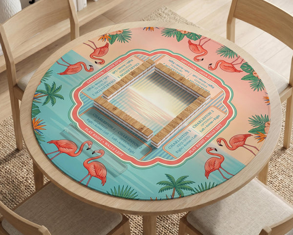 A square mahjong mat with flamingos, hibiscus flowers, palm leaves, and aqua water accents on a coral background with a scalloped edge.