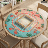 A square mahjong mat with flamingos, hibiscus flowers, palm leaves, and aqua water accents on a coral background with a scalloped edge.