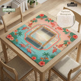 A square mahjong mat with flamingos, hibiscus flowers, palm leaves, and aqua water accents on a coral background with a scalloped edge.