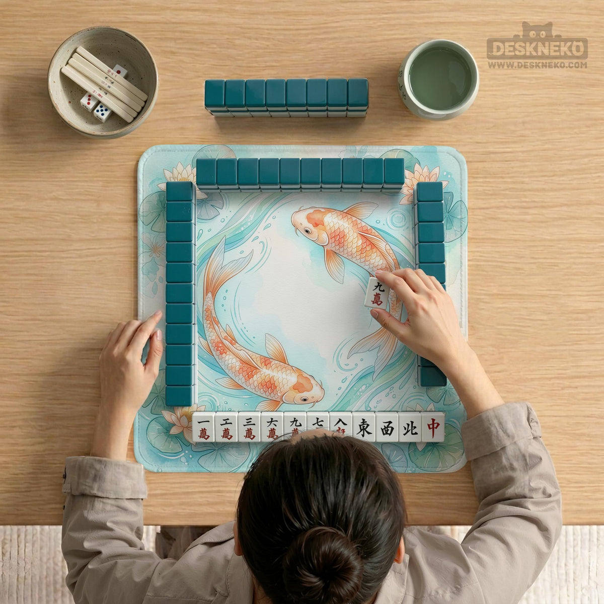 A soft blue mahjong mat with koi fish, floating lily pads, pale floral details, and a watercolor-style pond design.
