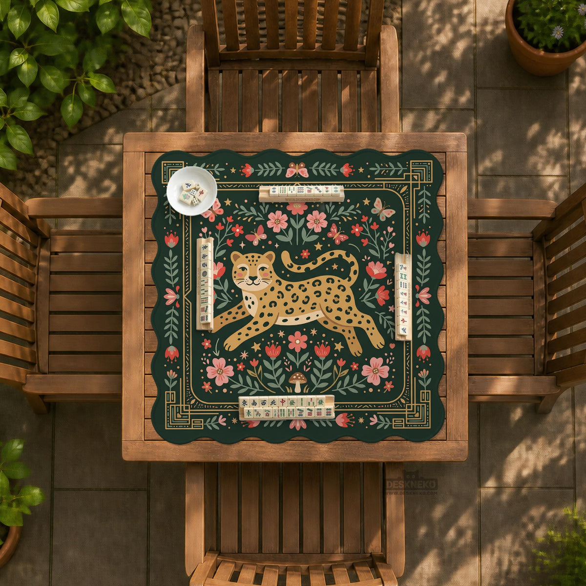 Dark green square mahjong mat with a golden spotted leopard in the center, surrounded by flowers, leafy stems, butterflies, and small star accents.