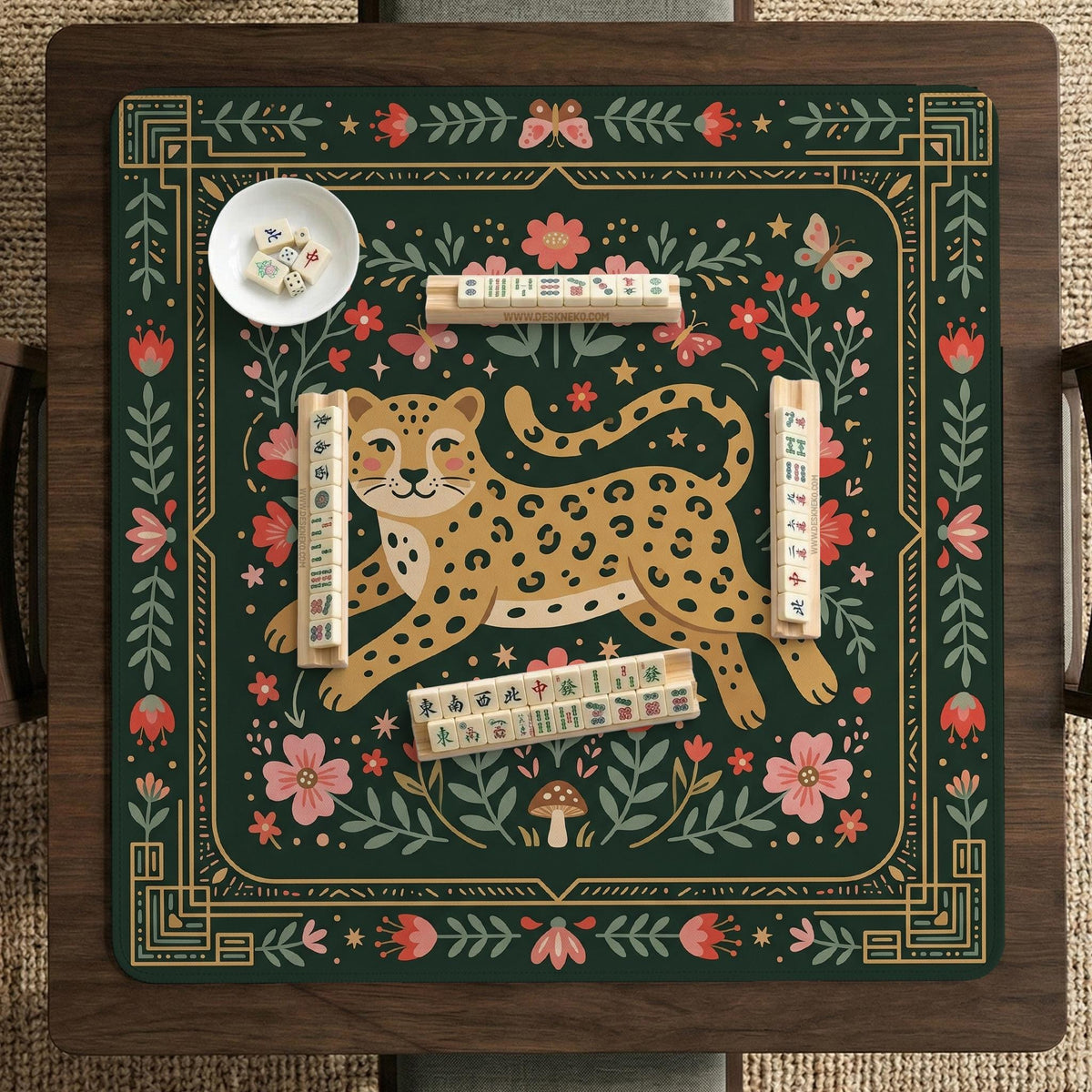 Dark green square mahjong mat with a golden spotted leopard in the center, surrounded by flowers, leafy stems, butterflies, and small star accents.