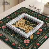 Dark green square mahjong mat with a golden spotted leopard in the center, surrounded by flowers, leafy stems, butterflies, and small star accents.