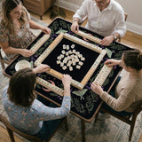 Black mahjong table mat with luna moths, purple flowers, soft green leaves, copper moons, and small star details.