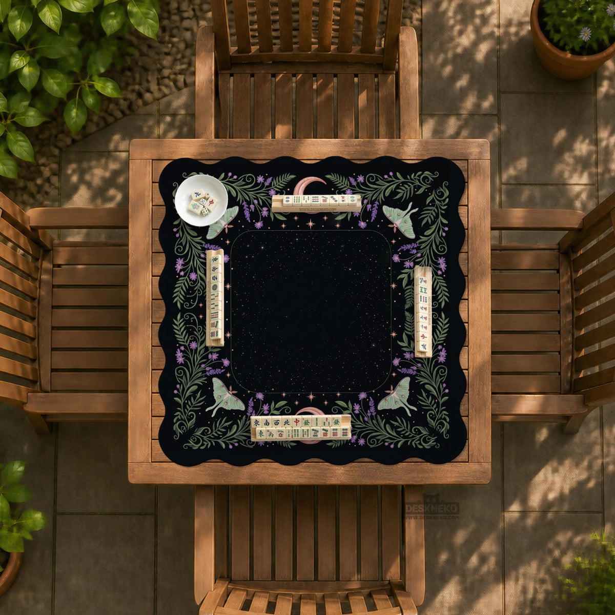 Black mahjong table mat with luna moths, purple flowers, soft green leaves, copper moons, and small star details.
