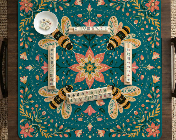 Green mahjong mat with a botanical bee and floral mandala design in teal, coral, cream, and gold.