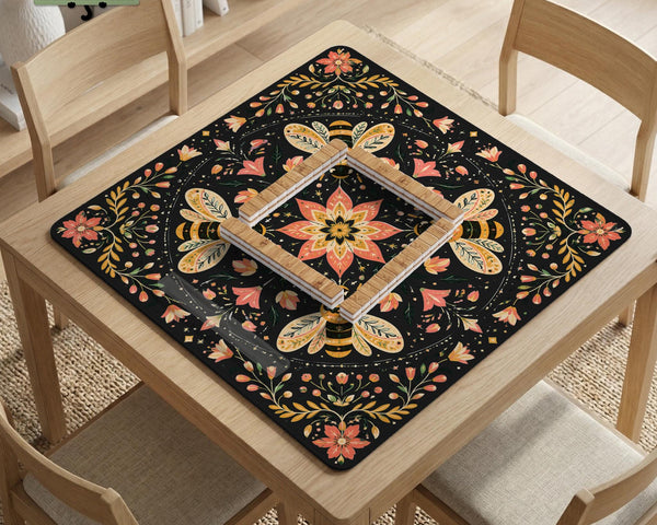 Black mahjong mat with a symmetrical botanical design, coral flowers, golden leaves, and small bees.