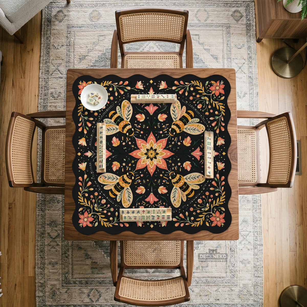 Black mahjong mat with a symmetrical botanical design, coral flowers, golden leaves, and small bees.
