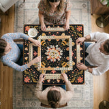Black mahjong mat with a symmetrical botanical design, coral flowers, golden leaves, and small bees.