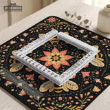 Black mahjong mat with a symmetrical botanical design, coral flowers, golden leaves, and small bees.