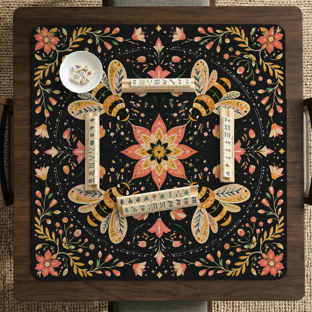 Black mahjong mat with a symmetrical botanical design, coral flowers, golden leaves, and small bees.