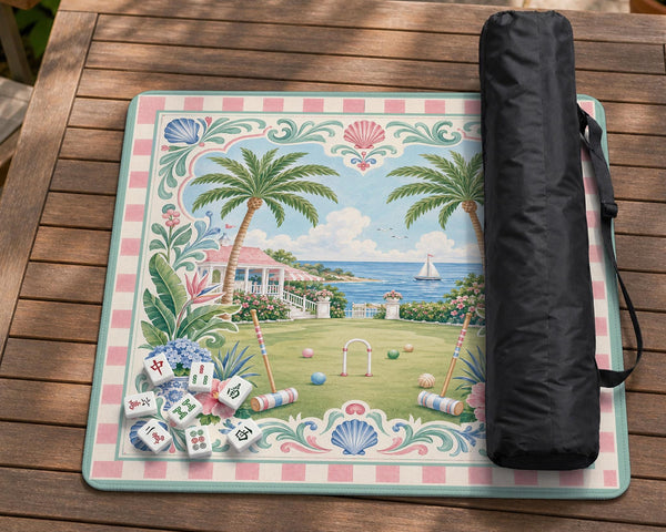 Pastel mahjong mat with a pink gingham border, seashells, hydrangea pots, palm trees, croquet details, and a coastal garden scene.