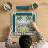 Pastel mahjong mat with a pink gingham border, seashells, hydrangea pots, palm trees, croquet details, and a coastal garden scene.