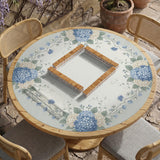 A square blue mahjong mat with hydrangea flowers, cream blossoms, sage leaves, and vines around a plain center play area. The edge is scalloped.