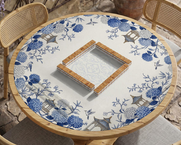 Blue and white square mahjong mat with a hydrangea and bird botanical border and a plain center area.