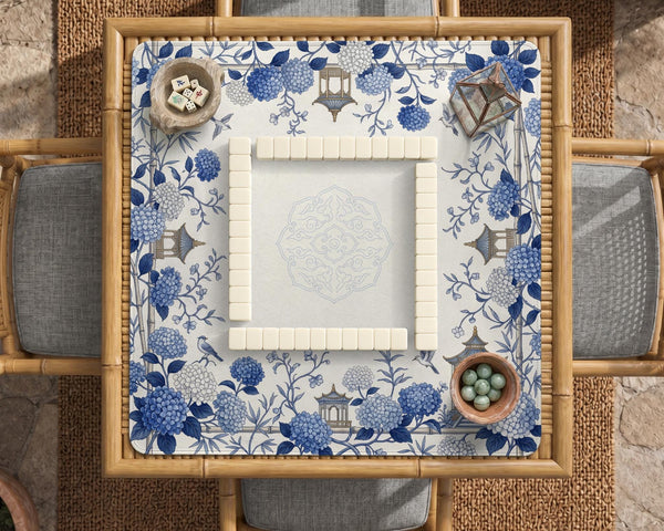 Blue and white square mahjong mat with a hydrangea and bird botanical border and a plain center area.