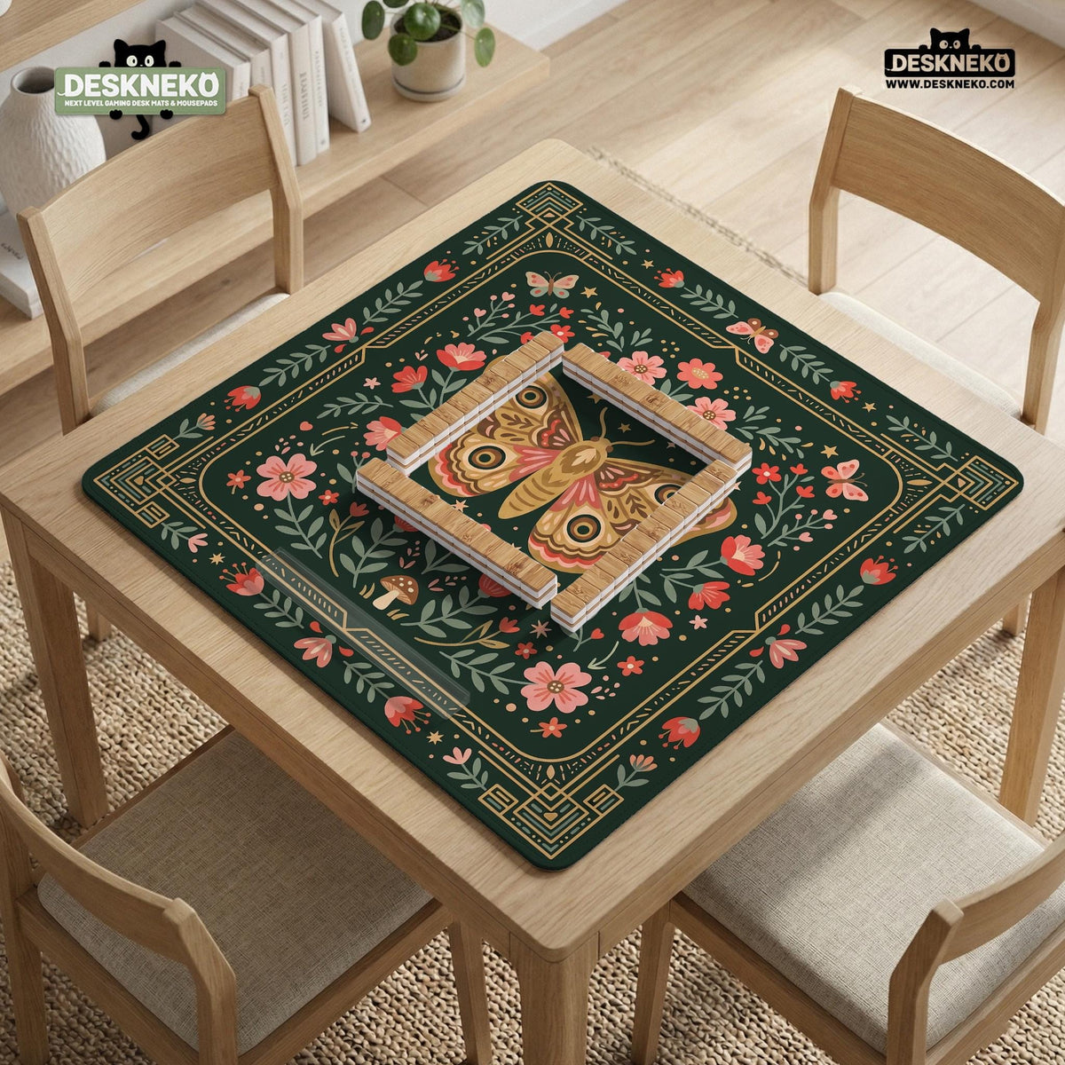 Dark green square mahjong mat with floral branches, small red blossoms, gold line details, and a large moth in the center.