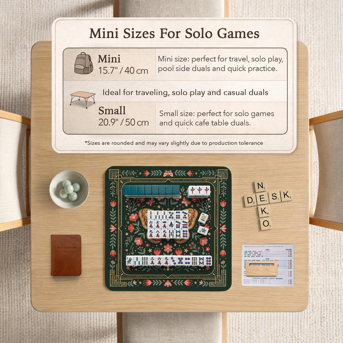 Dark green square mahjong mat with floral branches, small red blossoms, gold line details, and a large moth in the center.