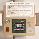 Dark green square mahjong mat with floral branches, small red blossoms, gold line details, and a large moth in the center.