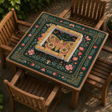 Dark green square mahjong mat with floral branches, small red blossoms, gold line details, and a large moth in the center.