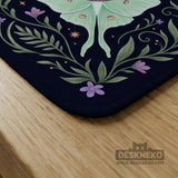 Navy square mahjong mat with a floral border, copper moons, scattered stars, pale moths, and leafy botanical details.
