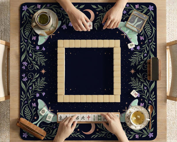 Navy square mahjong mat with a floral border, copper moons, scattered stars, pale moths, and leafy botanical details.