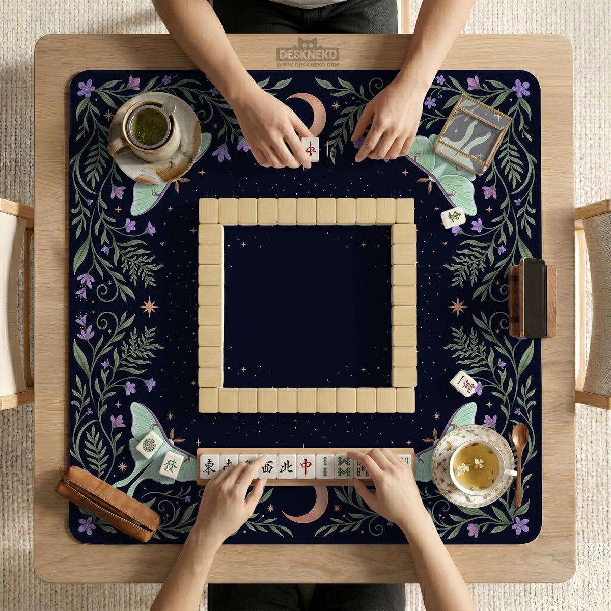 Navy square mahjong mat with a floral border, copper moons, scattered stars, pale moths, and leafy botanical details.