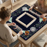 Navy square mahjong mat with a floral border, copper moons, scattered stars, pale moths, and leafy botanical details.