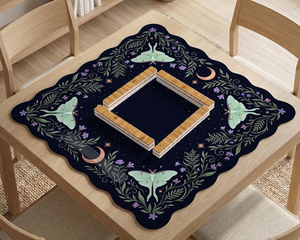 Navy square mahjong mat with a floral border, copper moons, scattered stars, pale moths, and leafy botanical details.