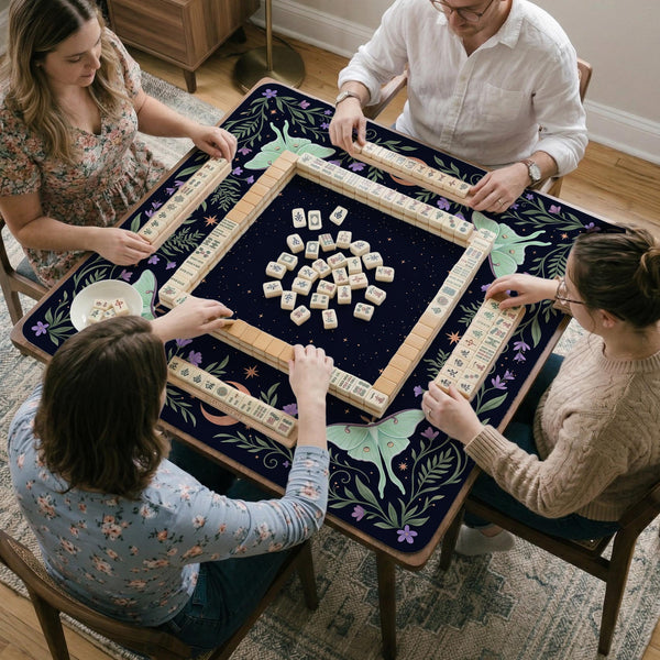 Navy square mahjong mat with a floral border, copper moons, scattered stars, pale moths, and leafy botanical details.