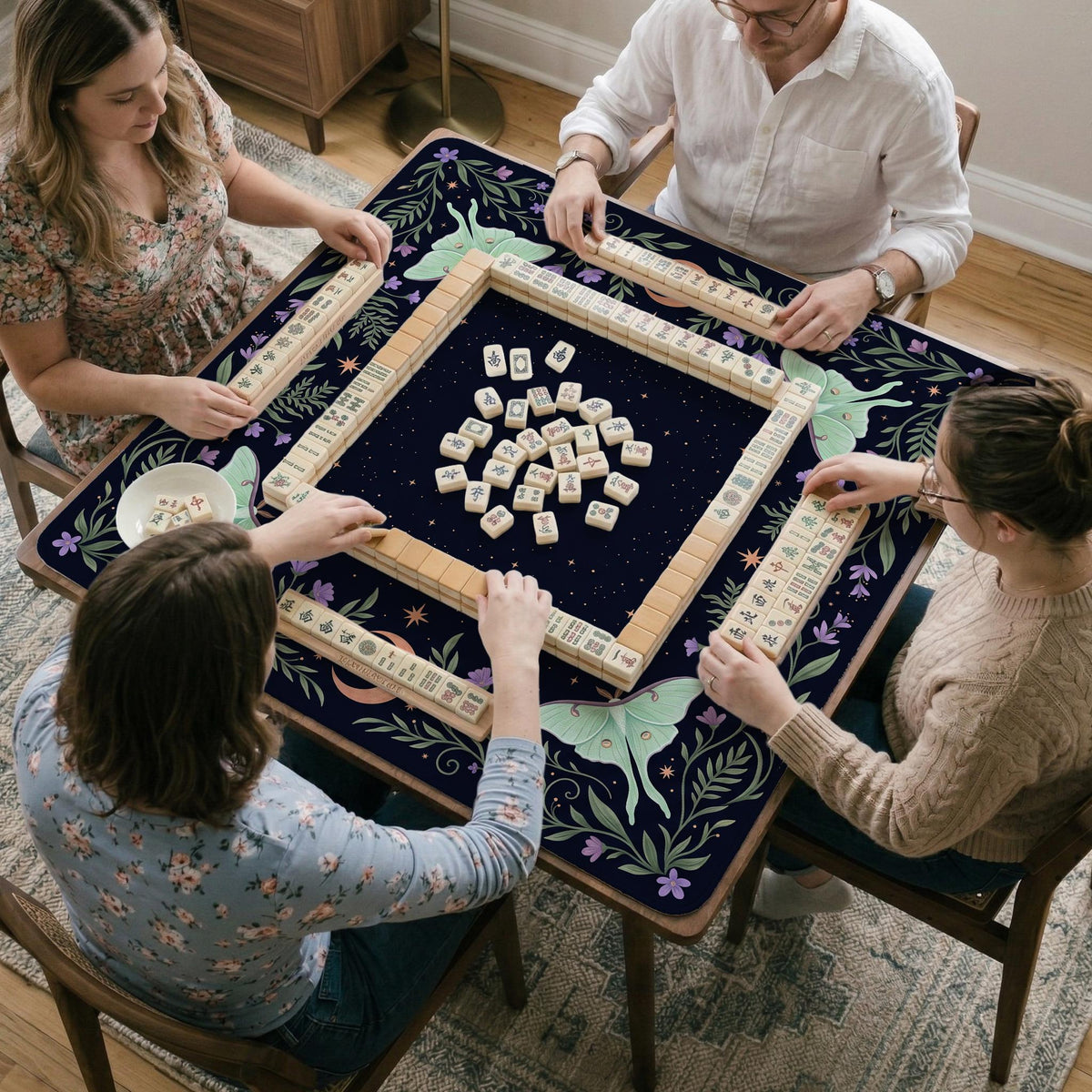 Navy square mahjong mat with a floral border, copper moons, scattered stars, pale moths, and leafy botanical details.