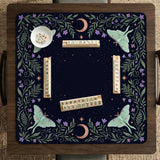 Navy square mahjong mat with a floral border, copper moons, scattered stars, pale moths, and leafy botanical details.