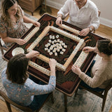 Black square mahjong mat with mirrored tiger faces, bamboo, dark tropical leaves, ornate border details, and orange accents.