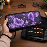Purple carrying case with black cat faces, moon shapes, stars, and crystal geode style artwork for Nintendo Switch.